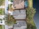 Aerial view of the home showcasing the roof, landscaping, and proximity to the lake at 10506 Sky Flower Ct, Land O Lakes, FL 34638