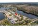 Aerial view of a home with a lake view in a suburban neighborhood at 10506 Sky Flower Ct, Land O Lakes, FL 34638