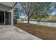 Backyard view with partial view of the lake, lush greenery, mature trees and plenty of space for outdoor enjoyment at 10506 Sky Flower Ct, Land O Lakes, FL 34638