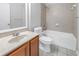 Bathroom featuring a vanity, toilet and tiled shower-tub combination at 10506 Sky Flower Ct, Land O Lakes, FL 34638