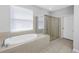 Bright bathroom boasting a soaking tub with tile surround and a glass-enclosed shower at 10506 Sky Flower Ct, Land O Lakes, FL 34638