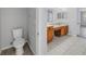 View of the toilet and sink area in the bathroom featuring tile floors at 10506 Sky Flower Ct, Land O Lakes, FL 34638