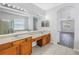 Spacious bathroom featuring double sinks and a doorway view into the bedroom at 10506 Sky Flower Ct, Land O Lakes, FL 34638
