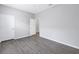 Vacant bedroom with laminate flooring, a ceiling fan, and a doorway to the bathroom at 10506 Sky Flower Ct, Land O Lakes, FL 34638
