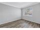 Cozy bedroom with modern vinyl flooring and window providing natural light at 10506 Sky Flower Ct, Land O Lakes, FL 34638