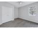 Bright bedroom features wood-look floors, closet and a window providing natural light at 10506 Sky Flower Ct, Land O Lakes, FL 34638