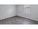 Empty bedroom featuring laminate flooring and a window with blinds at 10506 Sky Flower Ct, Land O Lakes, FL 34638