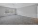 Spacious bedroom with a ceiling fan, plush carpeting, and a large sunlit window at 10506 Sky Flower Ct, Land O Lakes, FL 34638