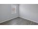 Unfurnished bedroom featuring laminate flooring, light gray walls, and a window at 10506 Sky Flower Ct, Land O Lakes, FL 34638