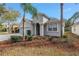 Charming single-story home featuring an arched entry, two-car garage, beautiful landscaping and mature palm trees at 10506 Sky Flower Ct, Land O Lakes, FL 34638