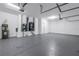 Large garage with a gray floor and utilities like a water heater and HVAC system, offering ample space at 10506 Sky Flower Ct, Land O Lakes, FL 34638
