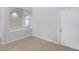 Hallway with tiled floors and a wall cutout, offering an interesting architectural detail and view at 10506 Sky Flower Ct, Land O Lakes, FL 34638