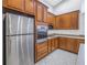 Kitchen showcasing stainless steel appliances, wooden cabinets, and white subway tile backsplash at 10506 Sky Flower Ct, Land O Lakes, FL 34638