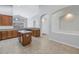 Spacious kitchen featuring warm wood cabinets, a central island, stainless steel appliances, and tile flooring at 10506 Sky Flower Ct, Land O Lakes, FL 34638