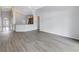 Spacious living room area featuring sleek wood flooring and easy access to the kitchen and entryway at 10506 Sky Flower Ct, Land O Lakes, FL 34638