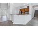Inviting open living space with kitchen access, featuring sleek wood flooring and natural light at 10506 Sky Flower Ct, Land O Lakes, FL 34638