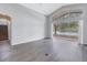 Bright living room with hardwood floors, vaulted ceilings, large windows that let in natural light, and a view of the outdoors at 10506 Sky Flower Ct, Land O Lakes, FL 34638