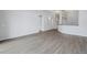 Bright living area with wood flooring and arched doorways, creating an open and airy feel at 10506 Sky Flower Ct, Land O Lakes, FL 34638