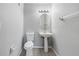Efficient powder room featuring tile flooring, a pedestal sink, and a toilet at 10506 Sky Flower Ct, Land O Lakes, FL 34638