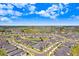 An aerial view of a home near a community lake and green spaces at 10998 Gable Dig Loop, San Antonio, FL 33576