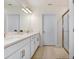 Modern bathroom with double vanity, glass shower, and sleek design at 10998 Gable Dig Loop, San Antonio, FL 33576