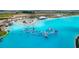 An aerial view of a large community pool with an aqua park and surrounding amenities at 10998 Gable Dig Loop, San Antonio, FL 33576