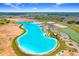 Expansive aerial view of community pool with beaches, bars, and restaurants on a sunny day at 10998 Gable Dig Loop, San Antonio, FL 33576