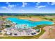 Wide aerial view of community lagoon, sandy beaches, bars, restaurants, and many activities at 10998 Gable Dig Loop, San Antonio, FL 33576