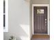 This home features a stylish front door with glass inset, and decorative trim at 10998 Gable Dig Loop, San Antonio, FL 33576