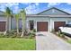 Charming villa featuring a well maintained front yard and an attached garage at 10998 Gable Dig Loop, San Antonio, FL 33576