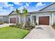 Charming villa featuring a well maintained front yard and an attached garage at 10998 Gable Dig Loop, San Antonio, FL 33576