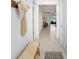 Bright hallway featuring light colored floors with a seating area and decor at 10998 Gable Dig Loop, San Antonio, FL 33576