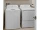 A laundry room featuring a white washer and dryer set at 10998 Gable Dig Loop, San Antonio, FL 33576