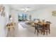 Open-concept living room featuring a dining area and access to a screened patio at 10998 Gable Dig Loop, San Antonio, FL 33576