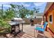 Backyard deck area with a grill, patio chairs, and a view of the home's exterior at 1111 32Nd N St, St Petersburg, FL 33713