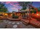 Outdoor deck featuring custom pergola, dining area, built-in grill, and cozy lighting at 1111 32Nd N St, St Petersburg, FL 33713