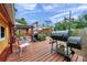 Expansive backyard featuring a wooden deck, covered patio with dining, grill and smoker, perfect for outdoor gatherings at 1111 32Nd N St, St Petersburg, FL 33713