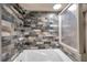 Bathroom features gray brick tile accent wall, shower head, and tub at 1111 32Nd N St, St Petersburg, FL 33713
