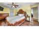 This cozy bedroom showcases hardwood floors, a ceiling fan, and natural light from the window at 1111 32Nd N St, St Petersburg, FL 33713