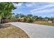 Spacious driveway offering ample parking, complemented by the home's exterior, landscaping, and fenced yard at 1111 32Nd N St, St Petersburg, FL 33713