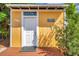 Inviting yellow home exterior with a white front door and charming coastal decor accents at 1111 32Nd N St, St Petersburg, FL 33713