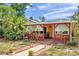 Charming home with inviting front porch, decorative lattice, and lush landscaping at 1111 32Nd N St, St Petersburg, FL 33713