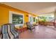 Cozy front porch with comfortable seating and a view of the landscaped yard at 1111 32Nd N St, St Petersburg, FL 33713