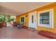 Inviting front porch with seating, bright yellow siding, and welcoming curb appeal at 1111 32Nd N St, St Petersburg, FL 33713