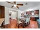 Open kitchen and dining area with elegant table, wood cabinets, and modern appliances at 1111 32Nd N St, St Petersburg, FL 33713
