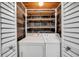Compact laundry room with washer, dryer, wooden ceiling, and shelves at 1111 32Nd N St, St Petersburg, FL 33713
