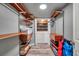 Open closet and laundry room with washer, dryer, and shelves at 1111 32Nd N St, St Petersburg, FL 33713