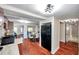Open-concept living room seamlessly connects to the kitchen, showcasing the hardwood floors and natural light at 1111 32Nd N St, St Petersburg, FL 33713