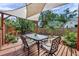 Outdoor patio features a shade sail covering a dining table, with views of the landscaped backyard at 1111 32Nd N St, St Petersburg, FL 33713