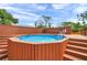 Backyard features an above ground pool, deck, and surrounding fence at 1111 32Nd N St, St Petersburg, FL 33713